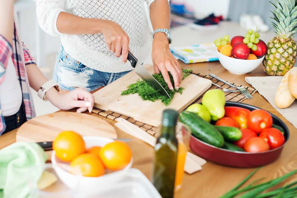 woman chopping vegetables in the kitchen