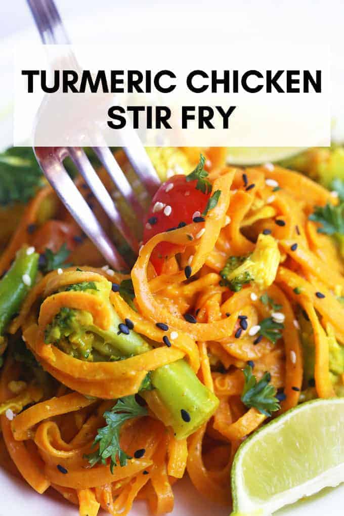 turmeric chicken stir fry with sweet potato noodles being picked up by a fork.