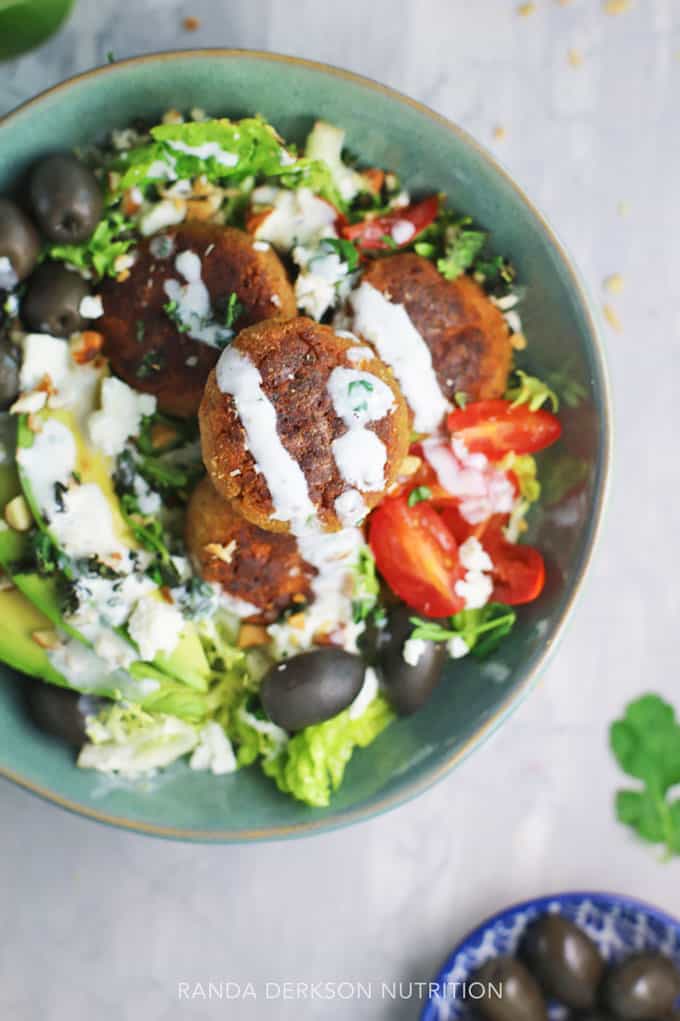 creamy yogurt dressing over baked falafel on a bed of greens.