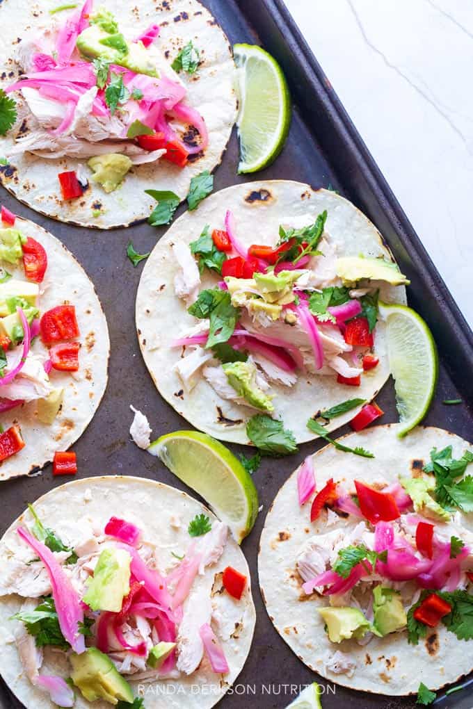 Pickled onion on tacos with lime, cilantro, and chicken