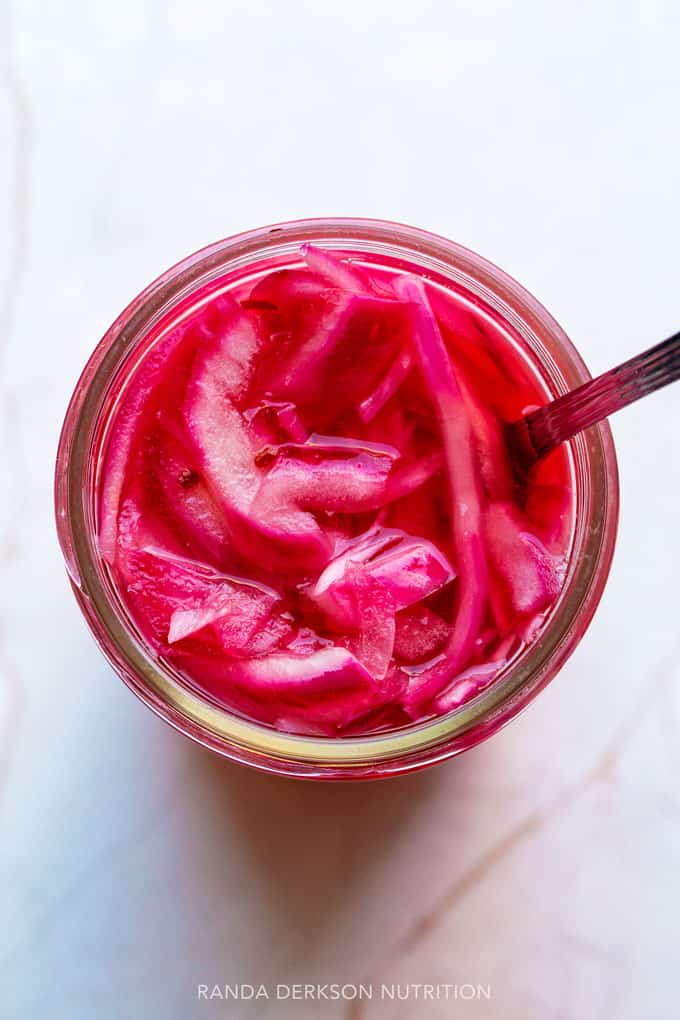 overhead view of pickled onions in a mason jar