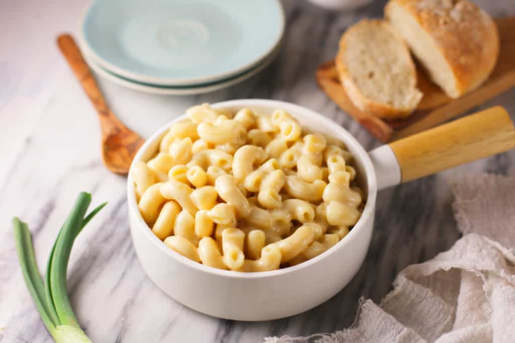 Creamy cauliflower macaroni and cheese in a handled bowl.