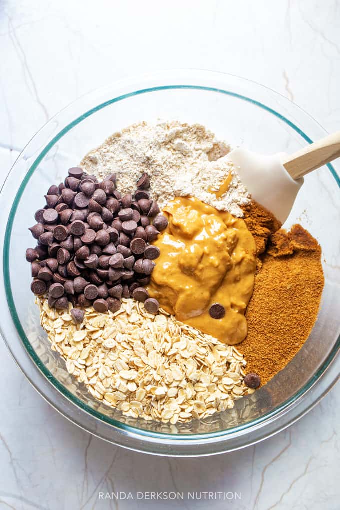 peanut butter oatmeal bars ingredients in a bowl being stirred