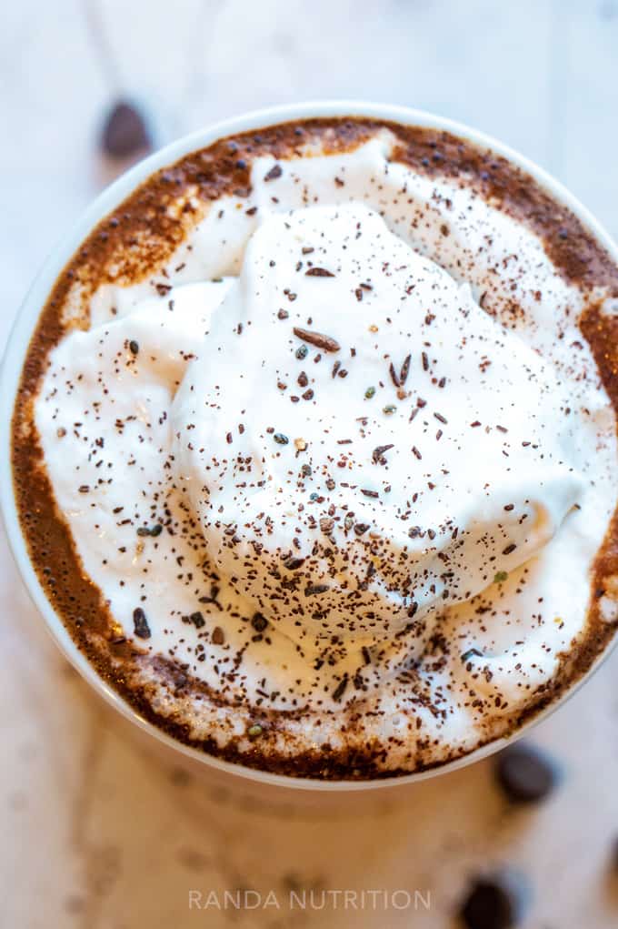 whipped coconut on top of cocoa in a mug