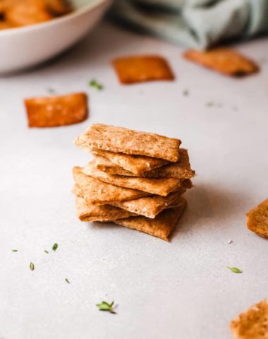 homemade quinoa crackers stacked for snacking