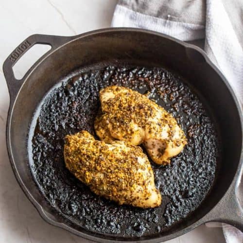 Whole30 chicken recipe: lemon oregano chicken baked in a cast iron pan.