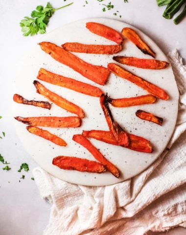 roasted carrot strips or fries on a platter