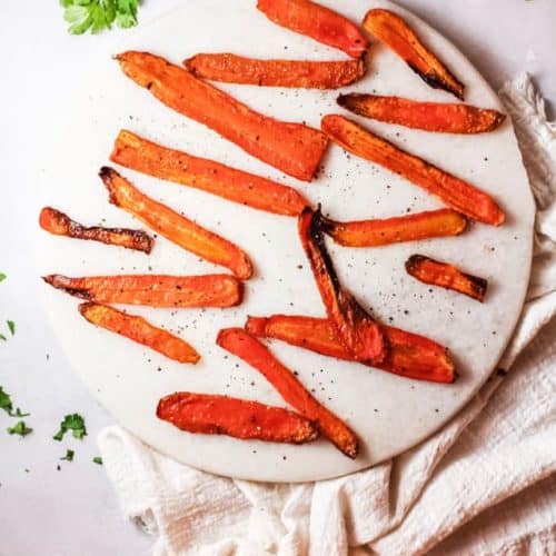 roasted carrot strips or fries on a platter