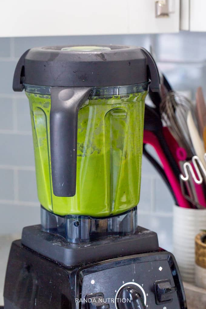 blending a green smoothie in a Vitamix