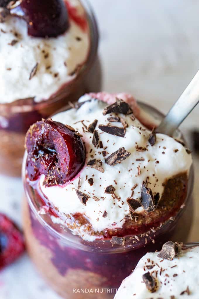 close up of Coco Whip and frozen dark cherries on a chia pudding