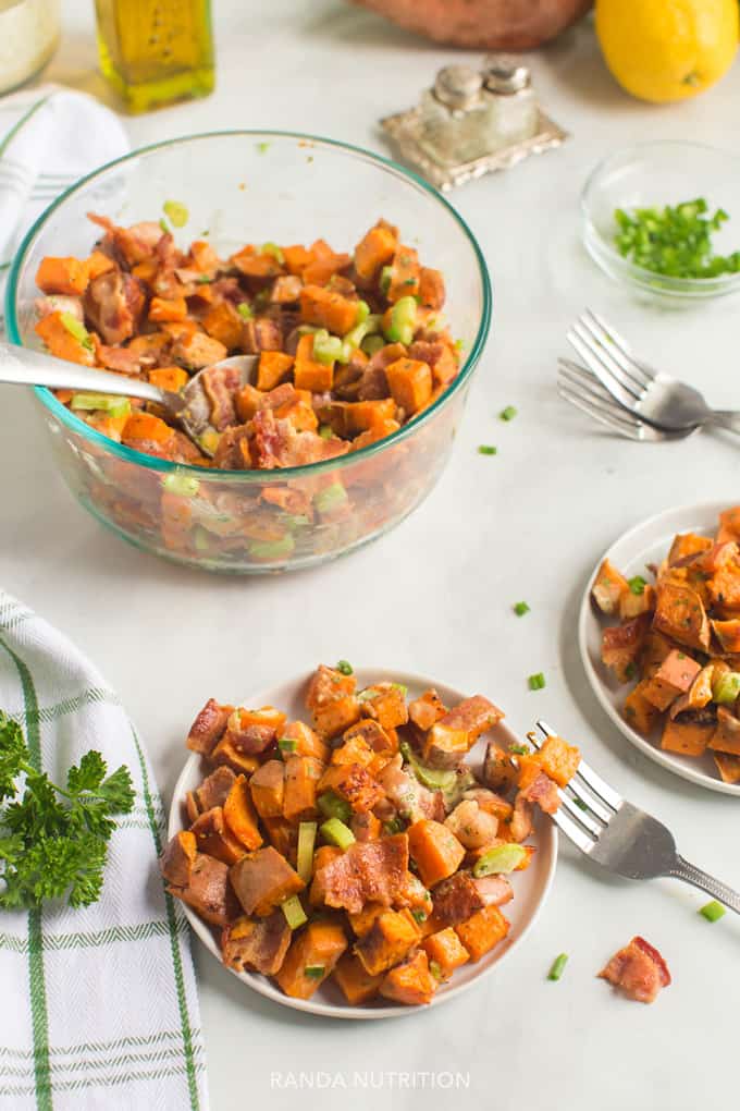 Over head shot of roasted sweet potatoes, bacon, and celery topped with a creamy dijon mayo lemon dressing.