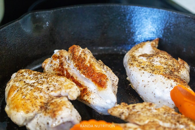 browning chicken in a cast iron pan