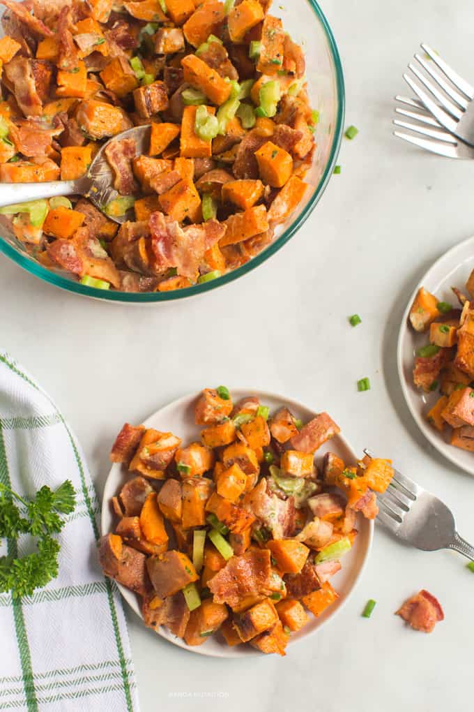 healthy roasted sweet potato salad on a plate with the serving bowl on the top left