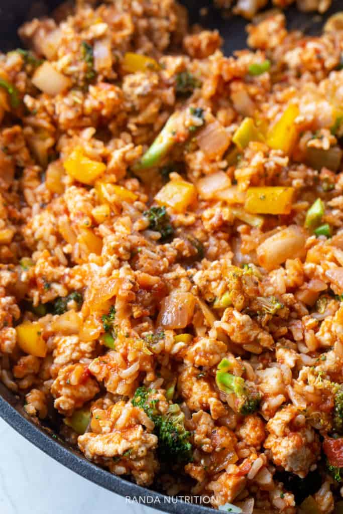 close up of cooked ground chicken with vegetables and marinara sauce