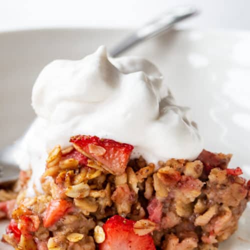 healthy baked oatmeal topped with fruit and coco whip