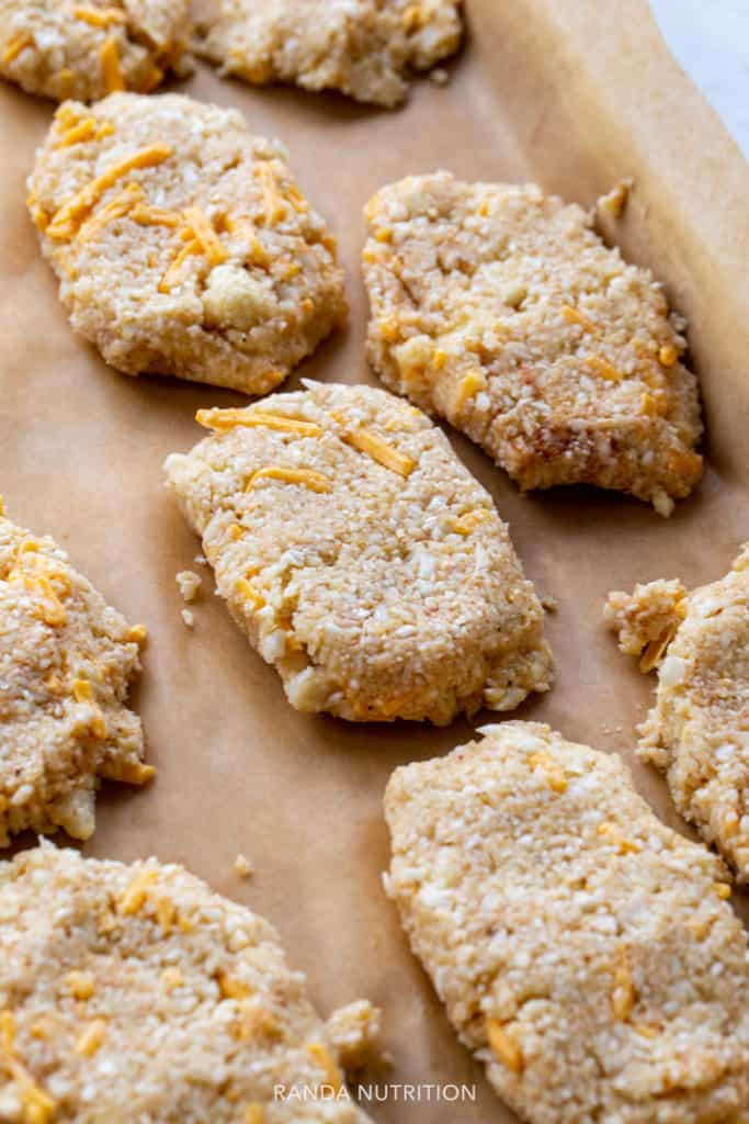 raw cauliflower shaped into hashbrown patties before they go in the oven