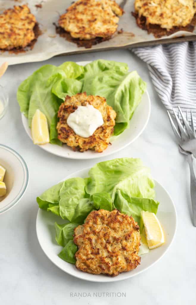 gluten free crab cakes on a bed of bibb lettuce and tartar sauce