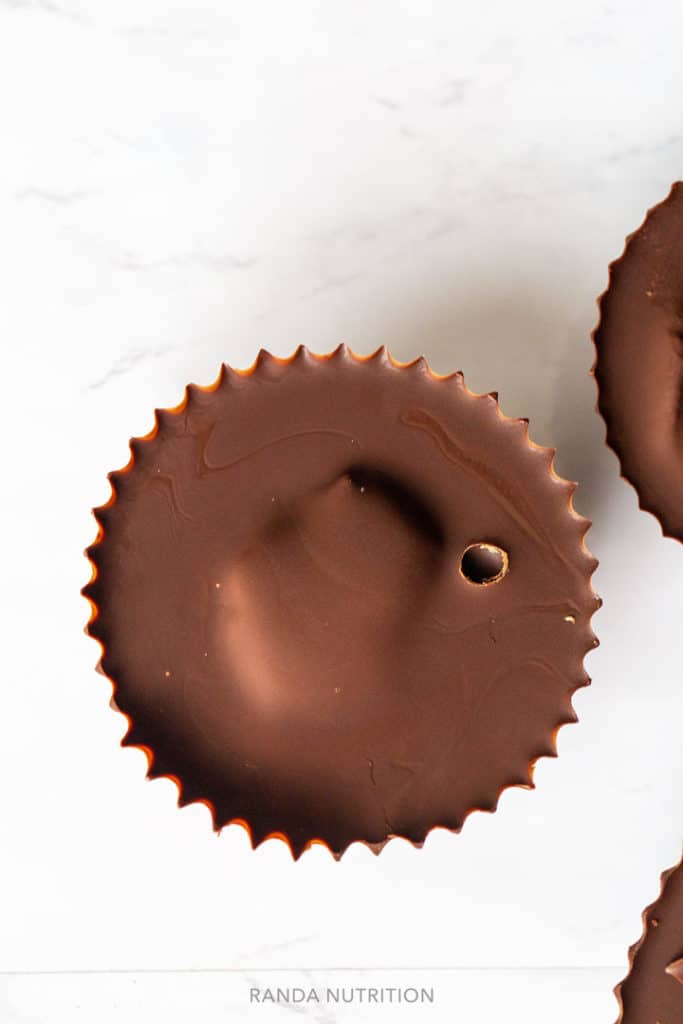 Over top view of chocolate cups with crisp lines and an air bubble on top of the chocolate