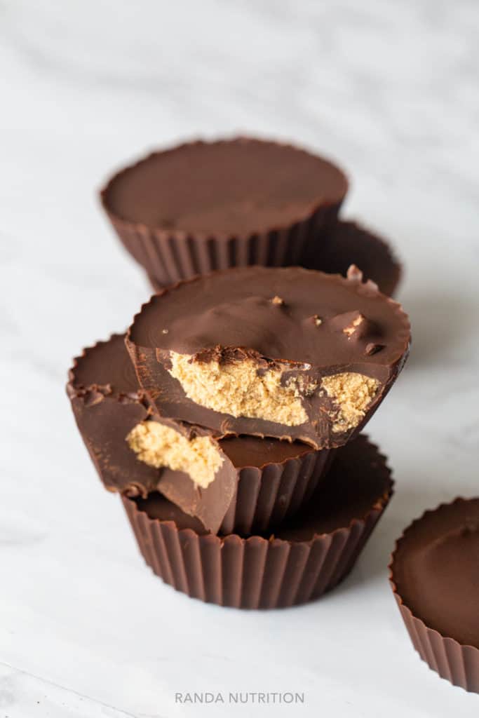 protein chocolate cups stacked with bites taken out to reveal the center