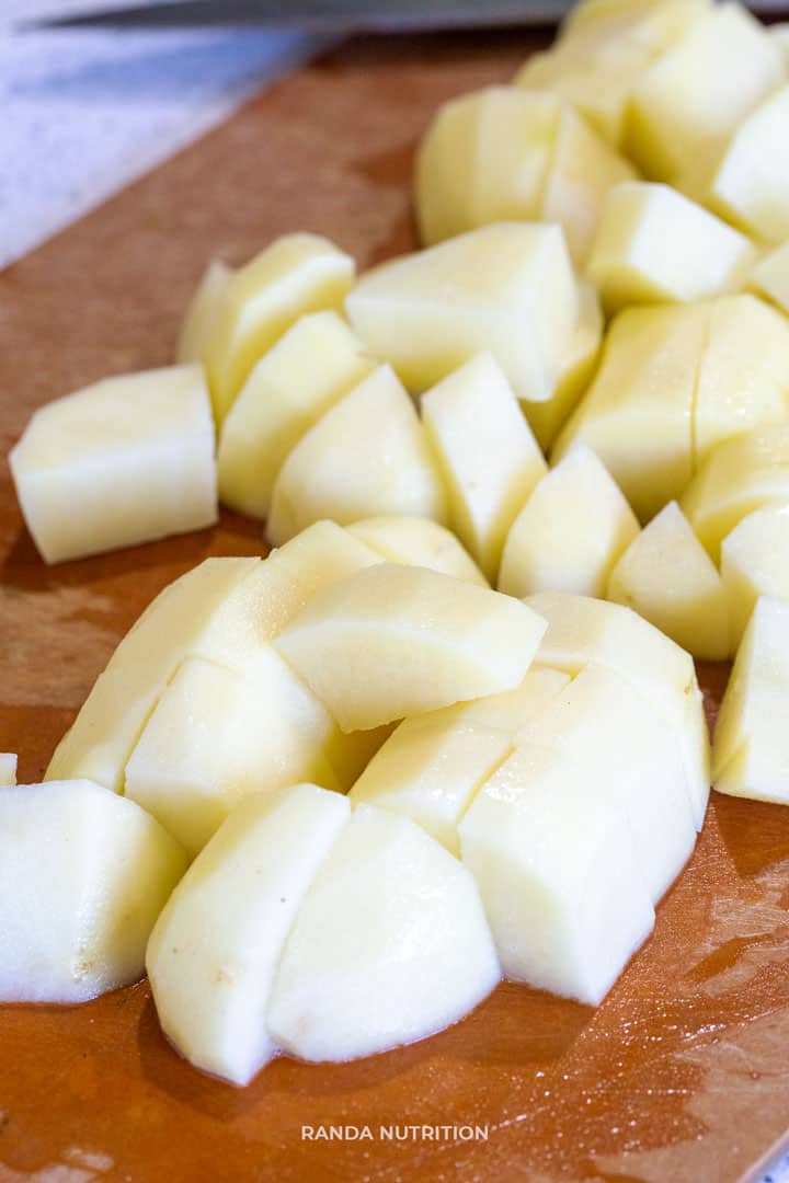 potatoes diced into quarters on a cutting board