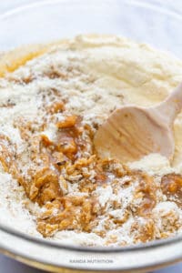 mixing gluten free flour into a pumpkin batter