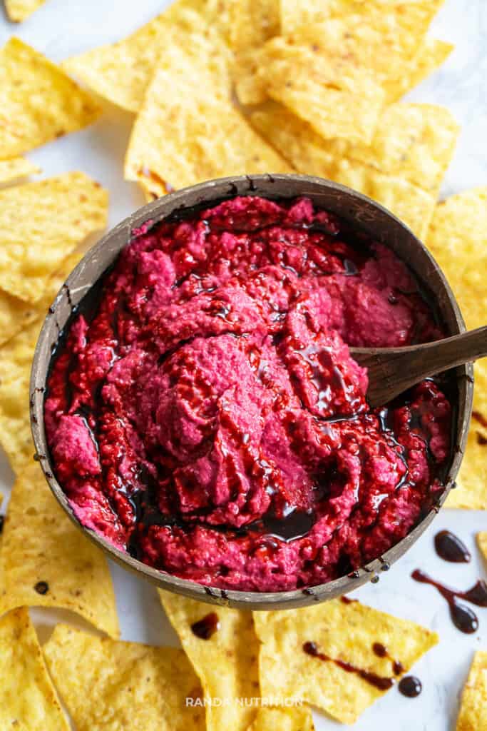 overhead view of beet hummus swirled with balsamic glaze