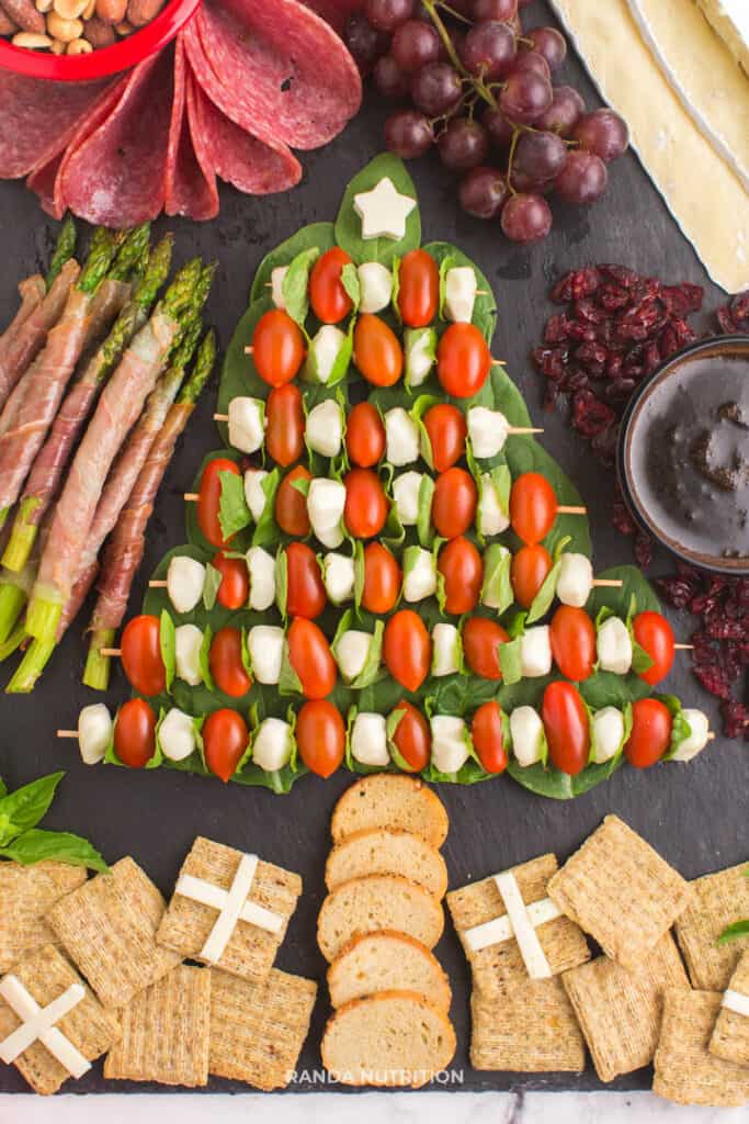 a charcuterie board in shape of a Christmas tree