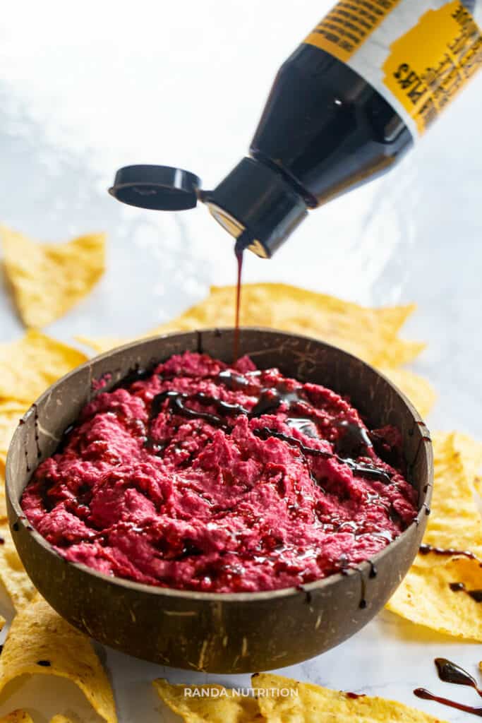 Nonna Pie's balsamic glaze being drizzled over beet dip