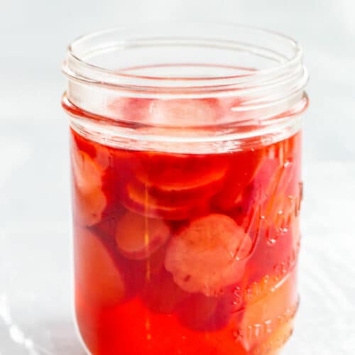 pickled radishes in a mason jar with apple cider vinegar