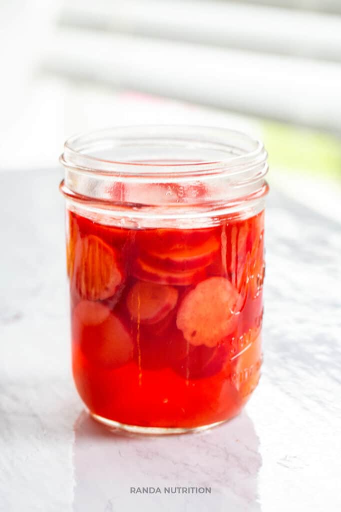 refrigerator pickled radishes in a brine on a table