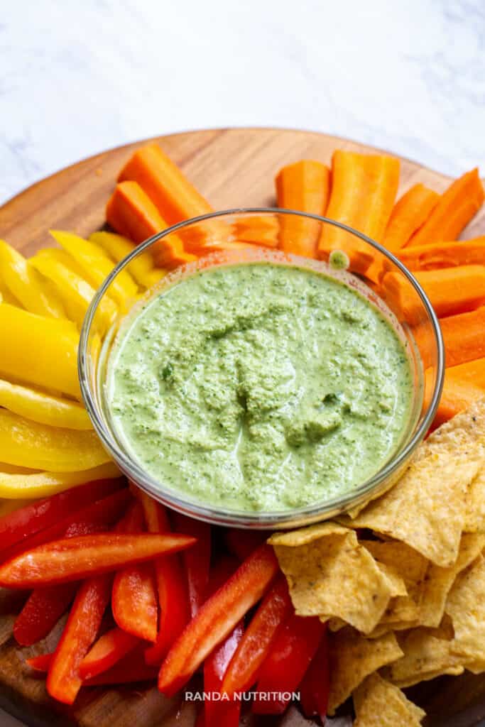 vegan dip with herbs served on a platter of veggies