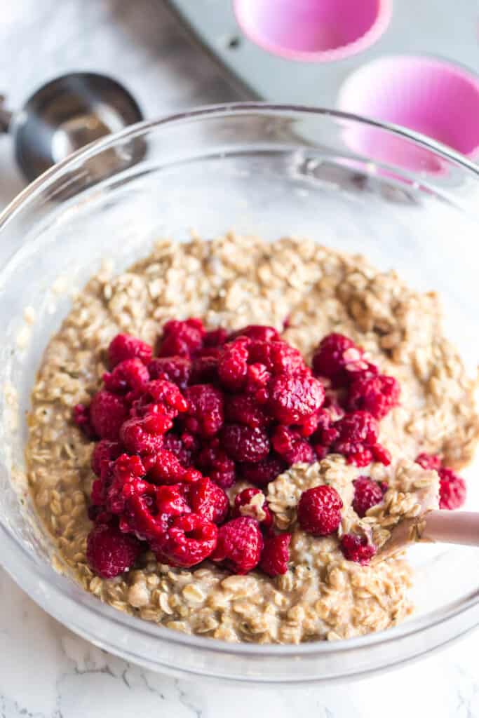 folding raspberries into oat muffin batter