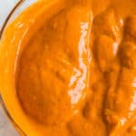 chicken breasts marinading in a homemade red pepper sauce
