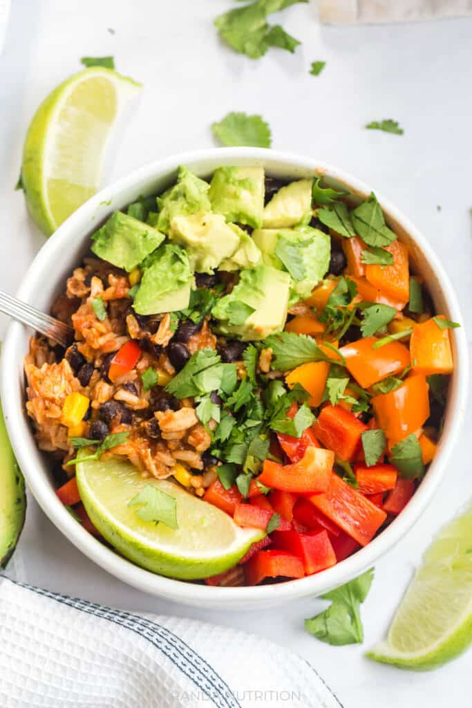 easy chicken burrito bowls that were cooked in the instant pot and topped with avocado and cilantro