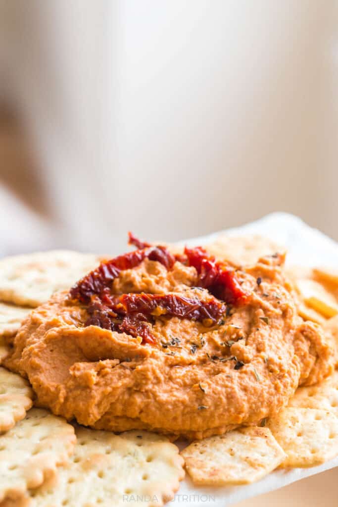 side view of hummus made with sun dried tomatoes