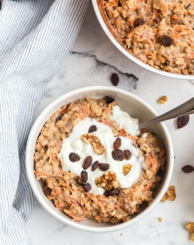 close up of oats with raisins, greek yogurt, and carrots with cinnamon