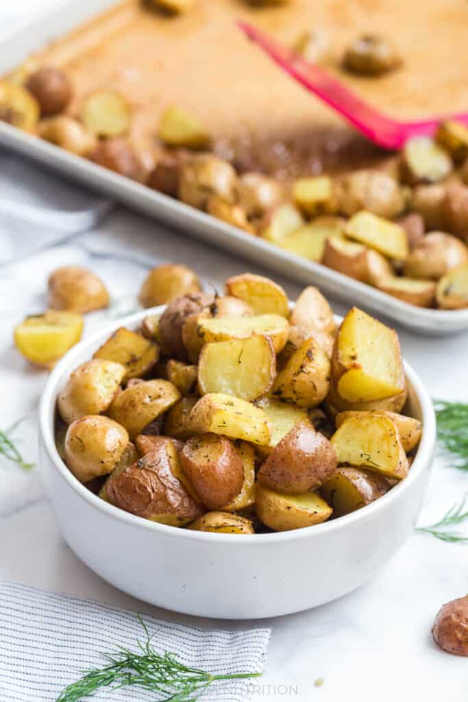 side shot of roasted potatoes in a white bowl