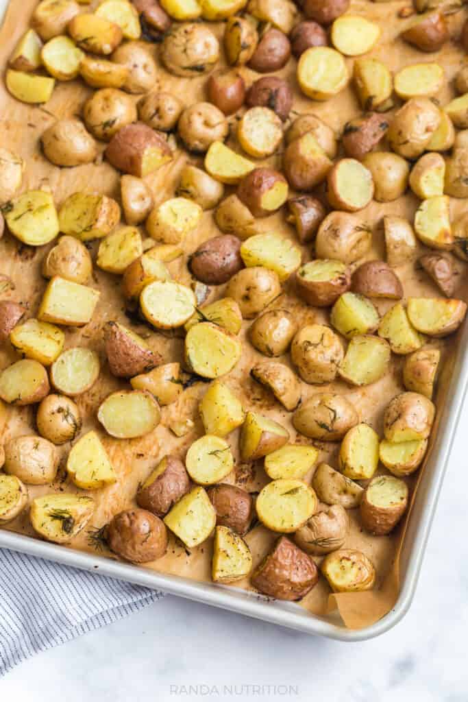 overhead view of these Lemon Roasted Potatoes with Garlic and Dill on a baking sheet