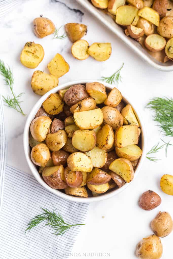 overhead view of these Lemon Roasted Potatoes with Garlic and Dill in a white bowl