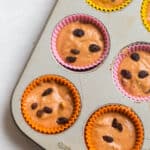 muffin batter in a tin lined with silicone cups