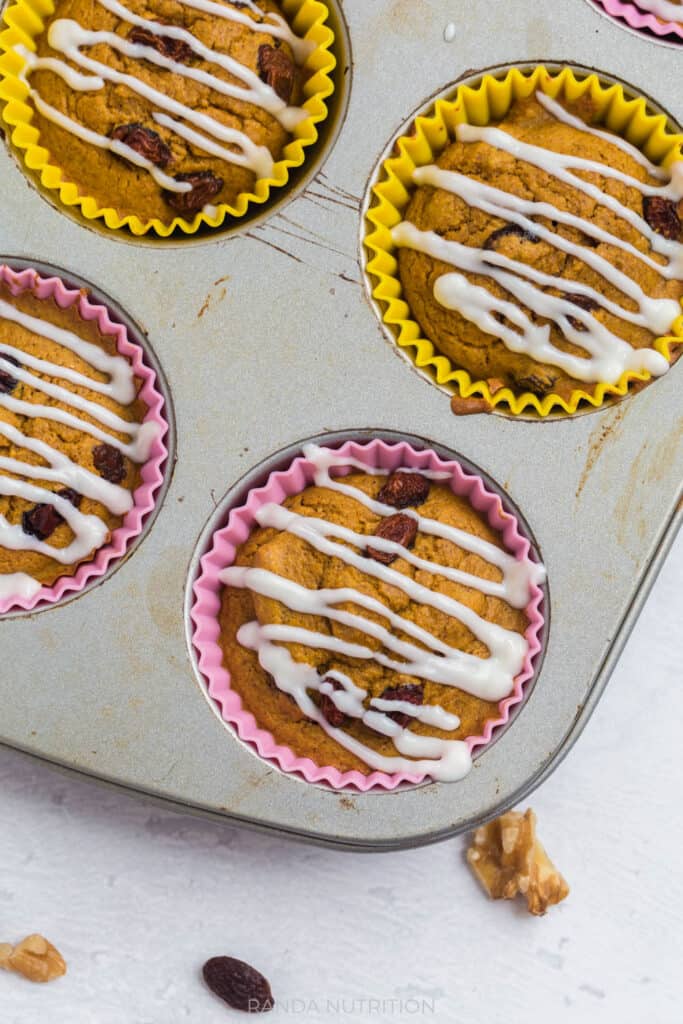 close up of carrot muffins with a cream cheese drizzle made out of greek yogurt