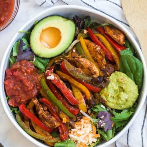 salad with chicken, bell peppers, guacamole, and salsa