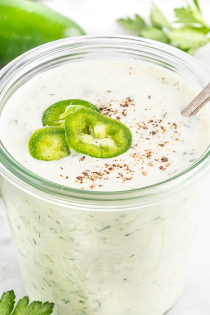 close up of homemade ranch with jalapenos