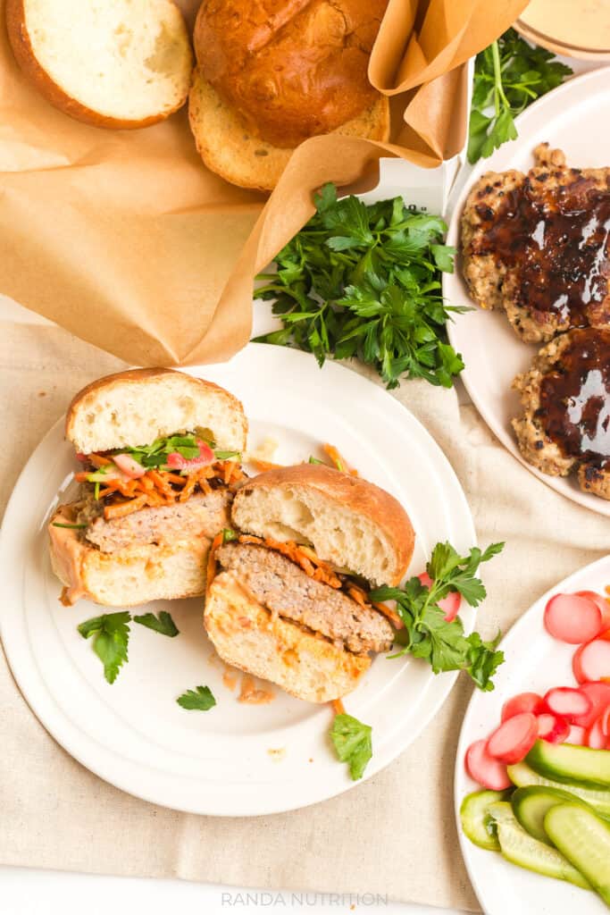 easy hoisin pork burgers topped with pickled carrots, radish, and cucumber