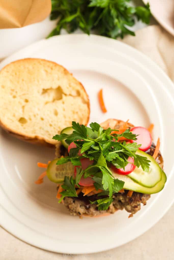 close up of pork burger with cilantro