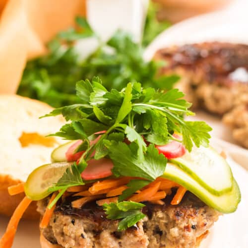 ground pork burger topped with hoisin sauce and pickled vegetables