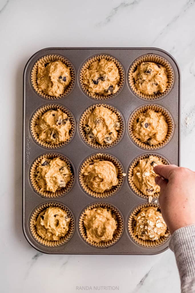 adding oats to muffins before baking