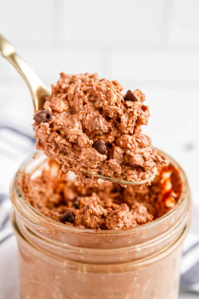 brownie overnight oats being lifted with a spoon out of a jar