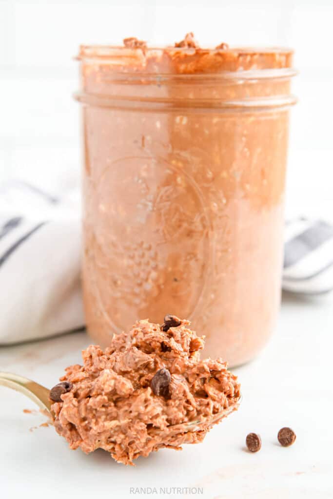 spoon of chocolate oats beside a jar