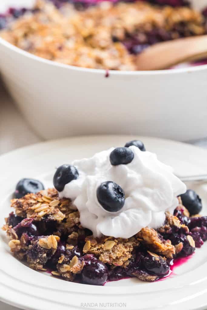 healthy blueberry crisp topped with So Delicious coco whip